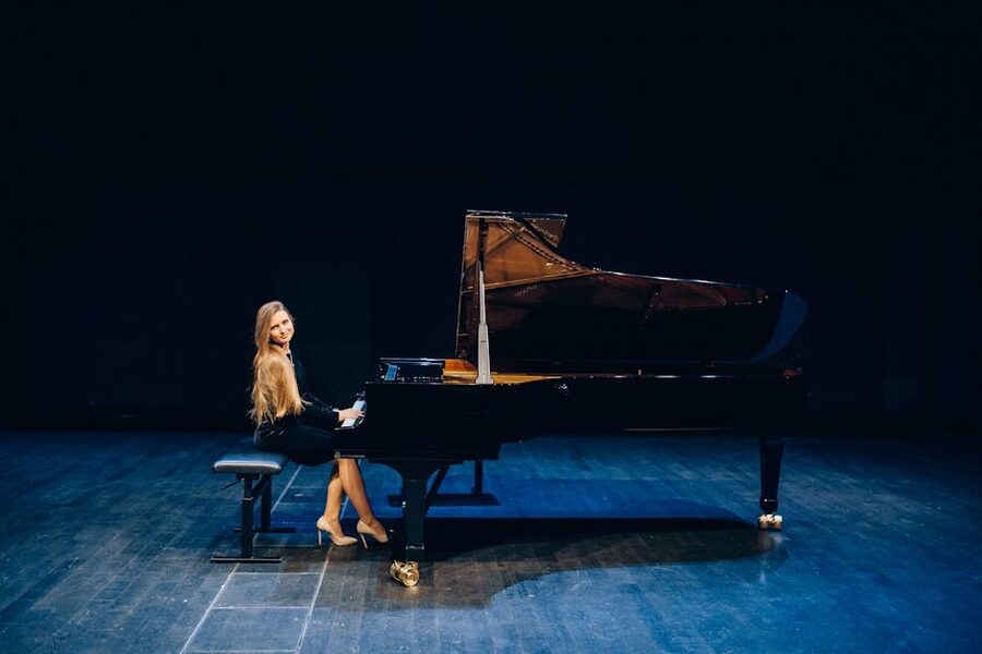 Pianist playing grand piano on a stage
