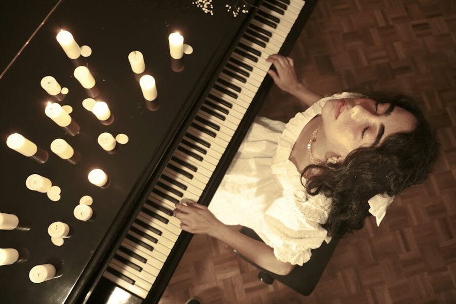 Pianist playing in a candlelit room