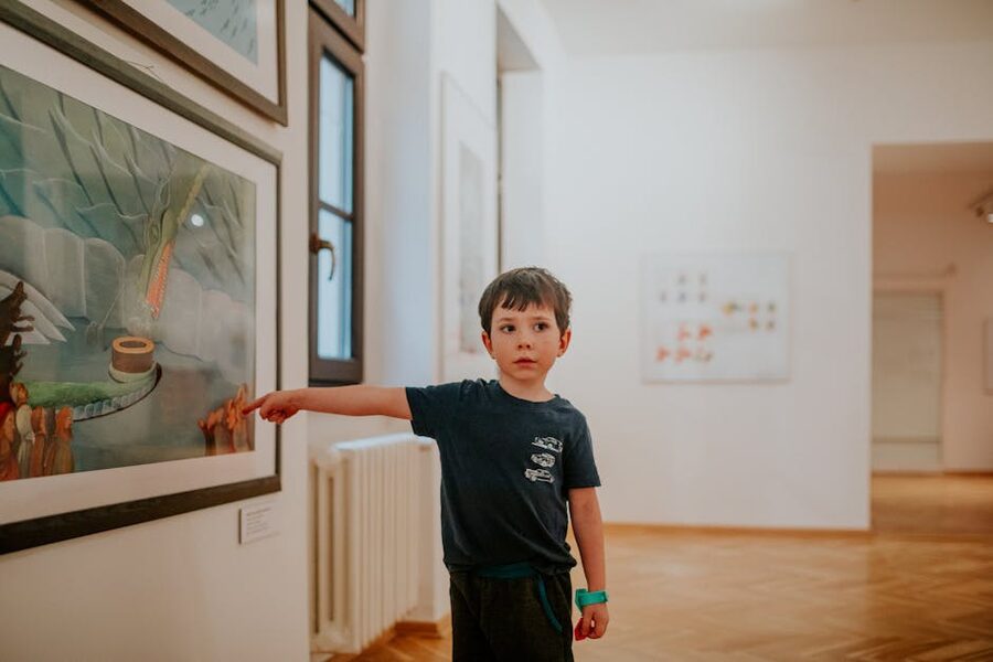 A child pointing at art in a modern gallery