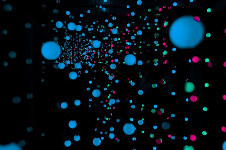 Glowing LED spheres in dark room art installation