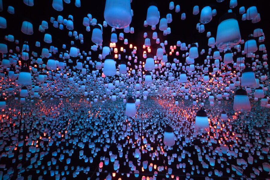 Hanging lantern installation in dark room similar to Cinema Mystica