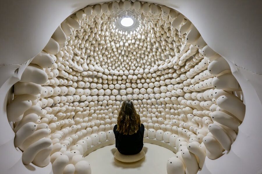 Visitor sitting in a quiet contemplative art installation room