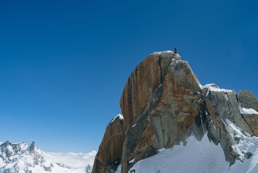 Climber at summit Chamonix snowy peak
