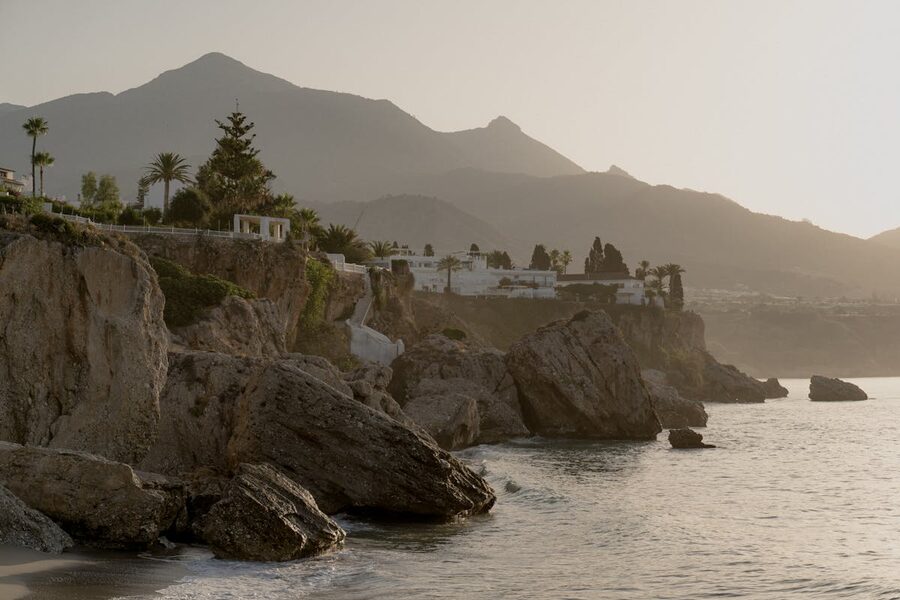 Dramatic Mediterranean coastal cliffs and mountains lit by golden sunrise light