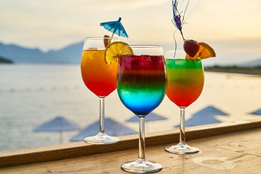 Colorful cocktails with garnishes at a sunset beach bar