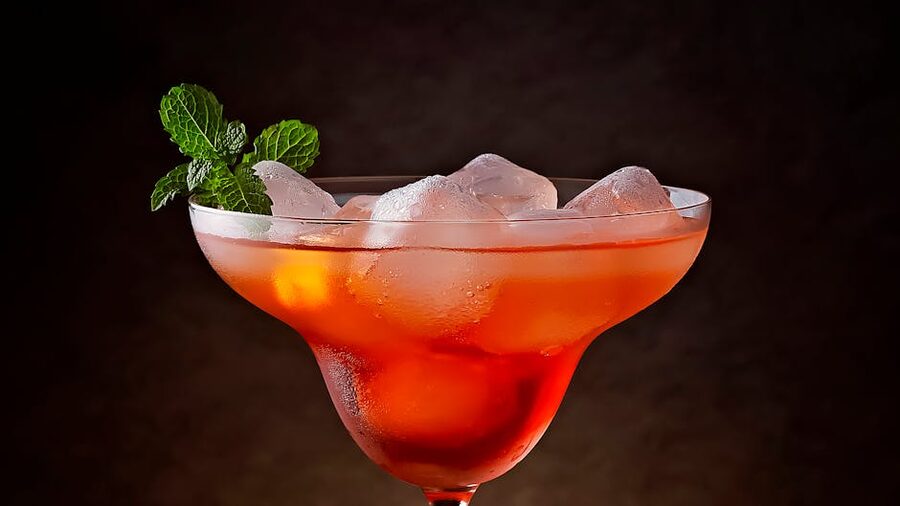 Cold red cocktail with ice and mint