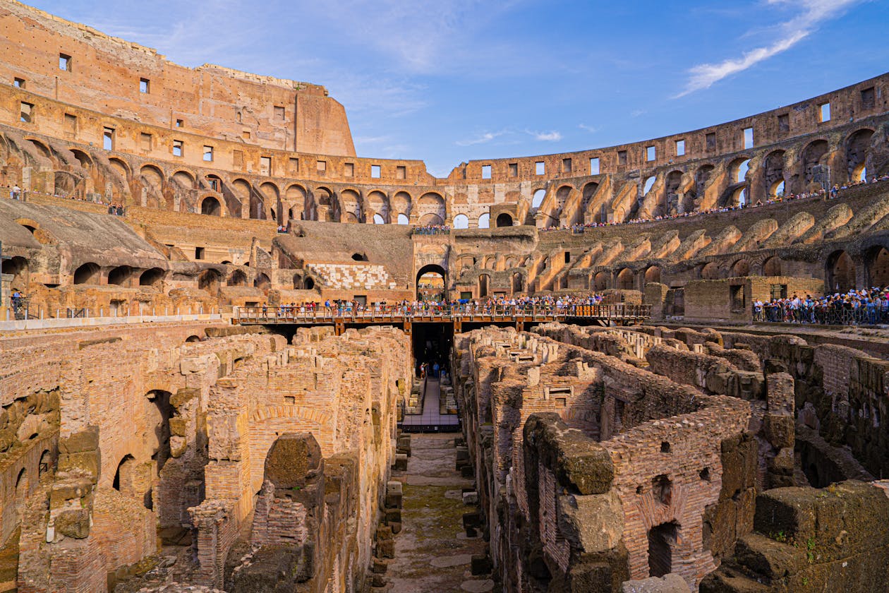 Bright interior view of the Colosseum with exposed underground levels