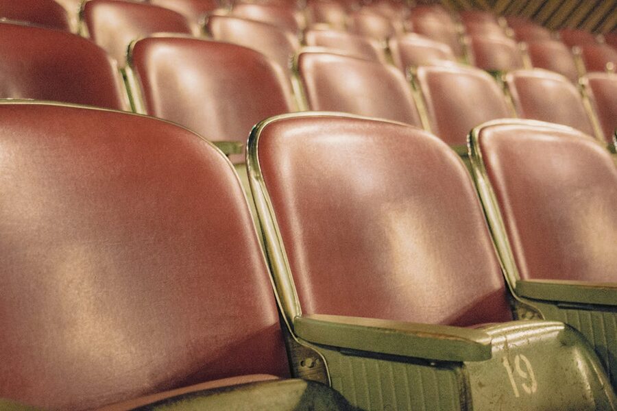 Empty red theater seats in auditorium