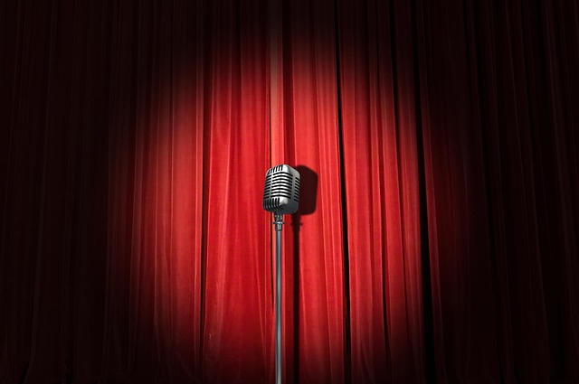 Stand-up comedy stage with curtain and microphone spotlight