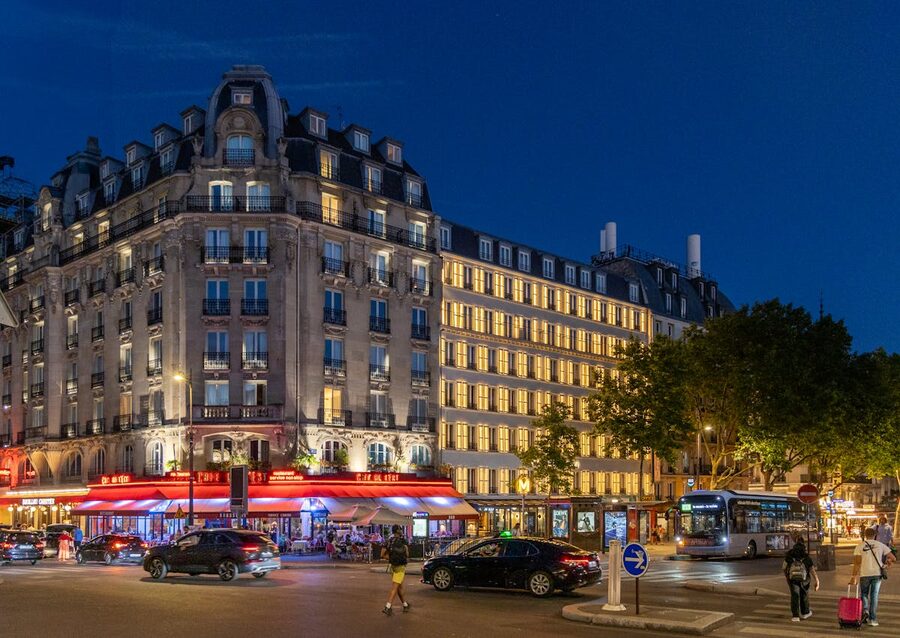 Paris street corner with lit cafes at twilight