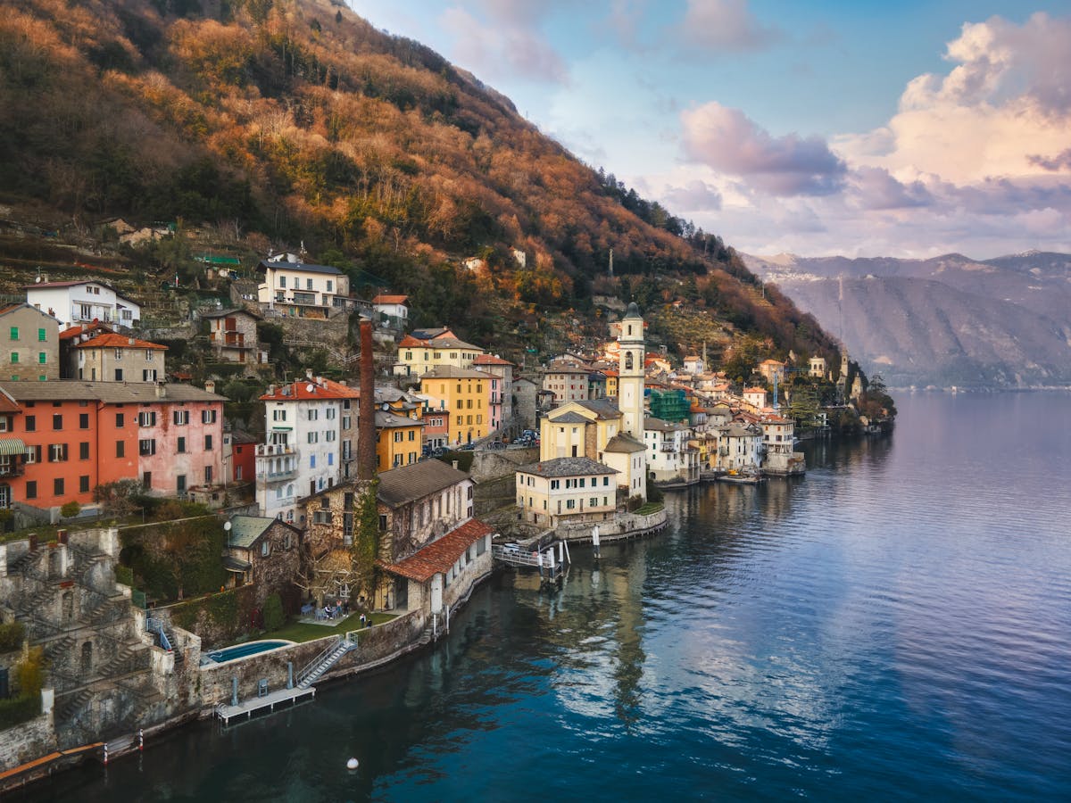 Aerial view of a town on Lake Como with surrounding mountains