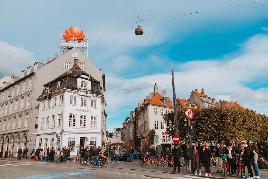 Pedestrians and historic buildings on a busy shopping street in Copenhagen Denmark