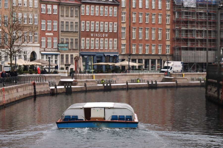 Canal cruise boat passing historic facades Copenhagen