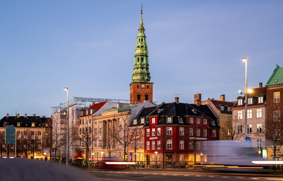 Historic Nikolaj Kunsthal church and Copenhagen cityscape at dusk