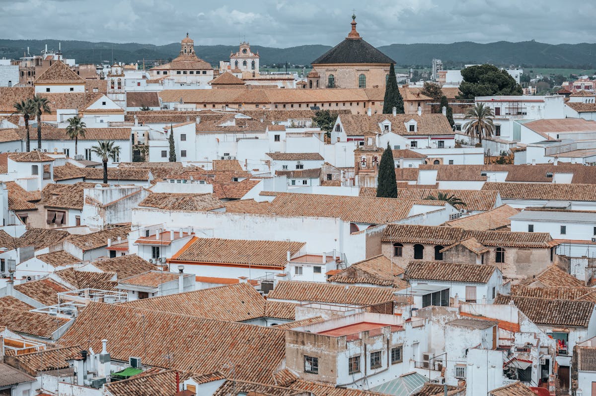 Aerial shot of traditional white rooftops in Cordoba with the Mosque-Cathedral visible