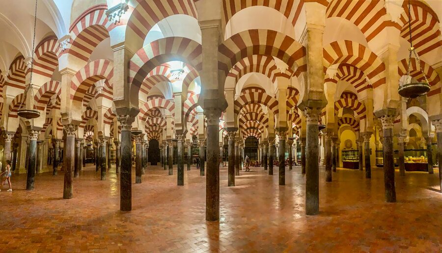 Interior arches of the Mosque-Cathedral of Cordoba with dramatic lighting