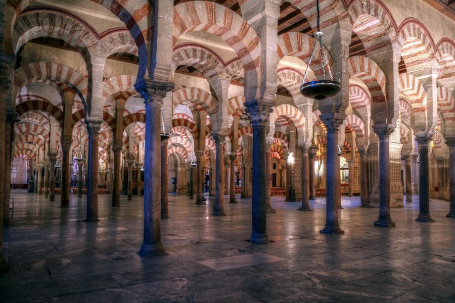 Forest of Moorish arches inside the Cordoba Mezquita stretching into the distance