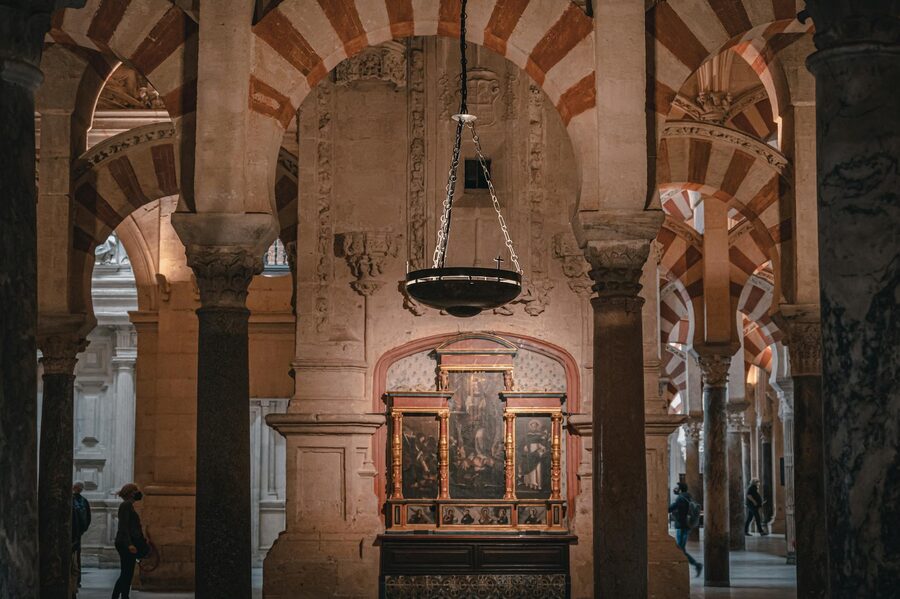 Red and white striped arches inside the Cordoba Mezquita creating a forest of stone