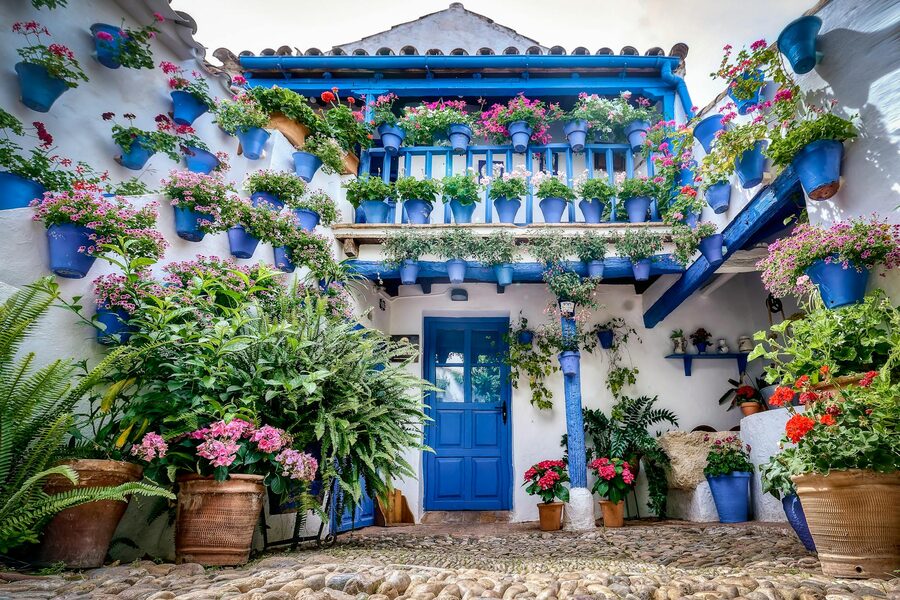 Traditional Cordoba patio overflowing with colorful potted flowers and plants
