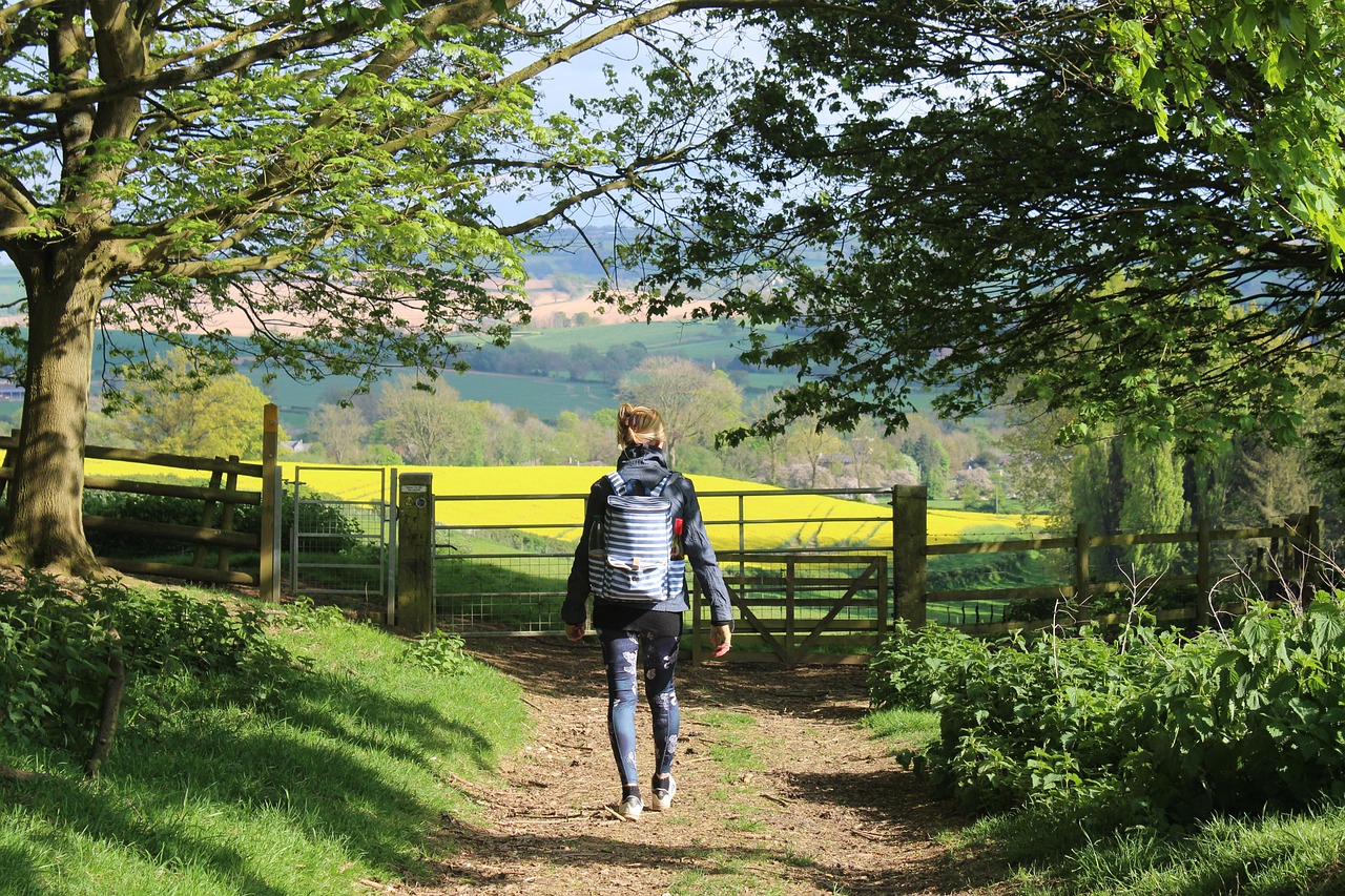 Walking path through green spring fields in the Cotswolds