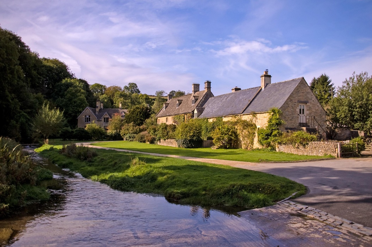 Stone cottage beside a stream in a Cotswolds village
