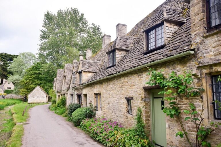 Row of traditional honey-coloured stone cottages in a Cotswolds village