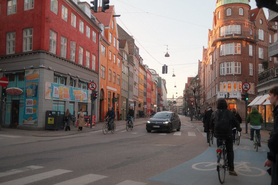 Bicycles and pedestrians on a colorful street in central Copenhagen Denmark