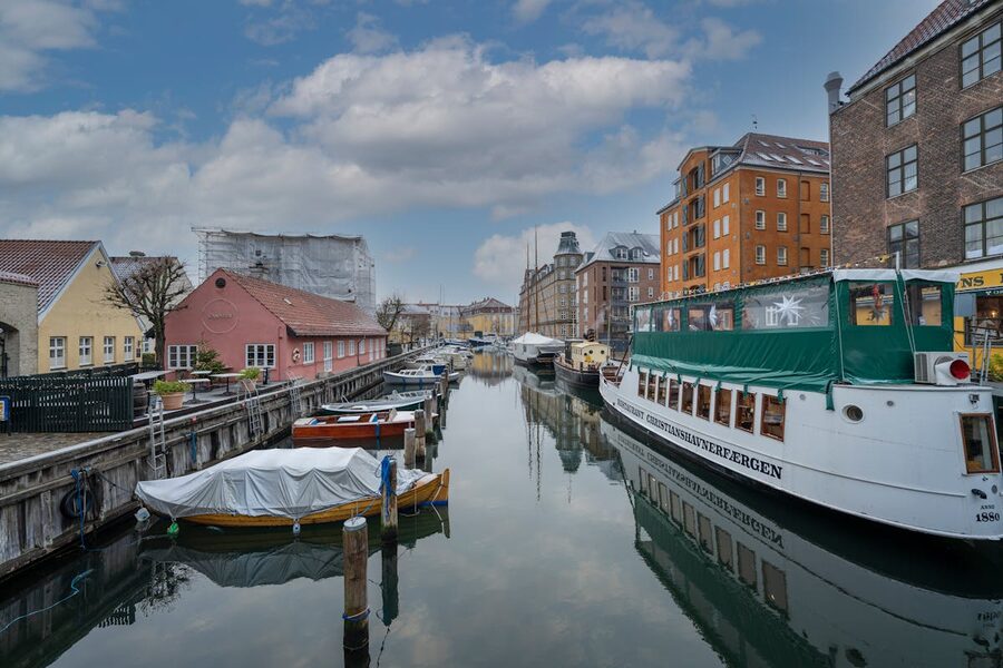 Copenhagen canal lined with historic buildings and boats