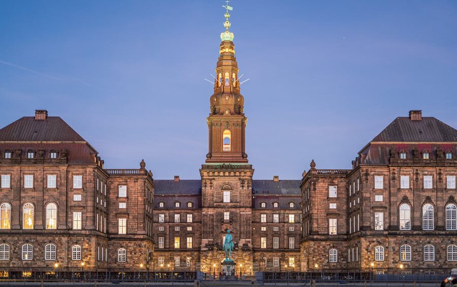 Christiansborg Palace illuminated at dusk in Copenhagen Denmark
