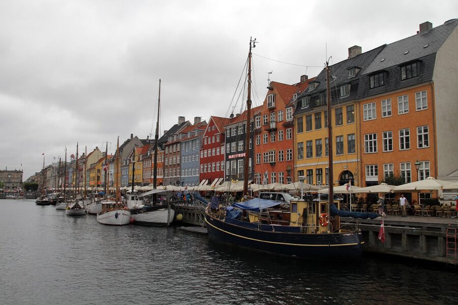 Nyhavn canal view with tourist boats and colorful buildings Copenhagen