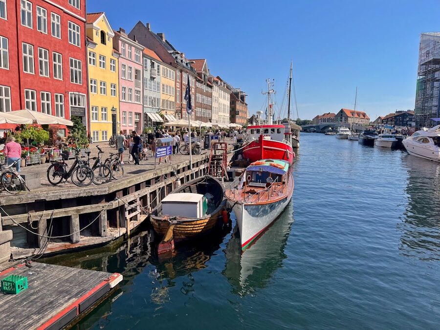 Colorful buildings and boats along Nyhavn canal on a sunny day in Copenhagen