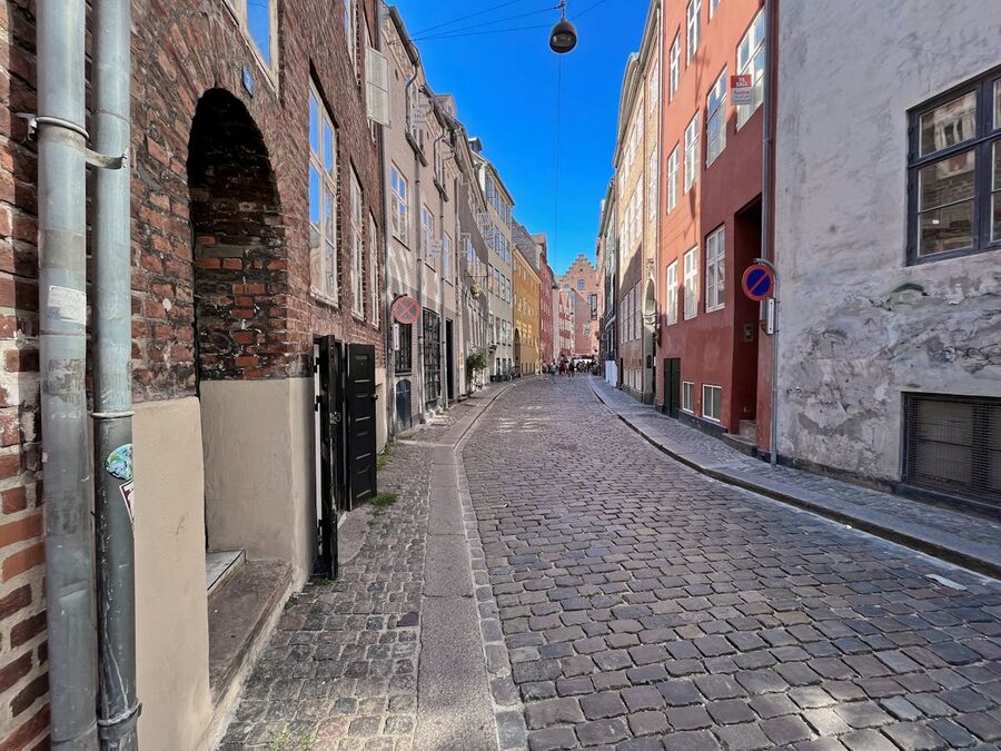Narrow cobblestone street with colorful buildings in Copenhagen old town