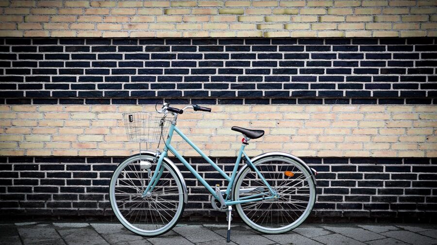 Vintage bicycle parked against a brick wall in Copenhagen