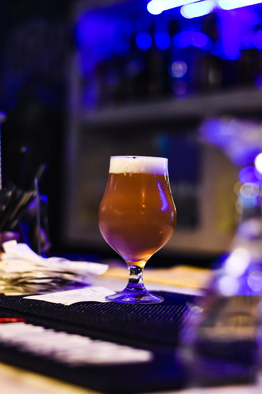 Craft beer on a bar counter at night with ambient lighting