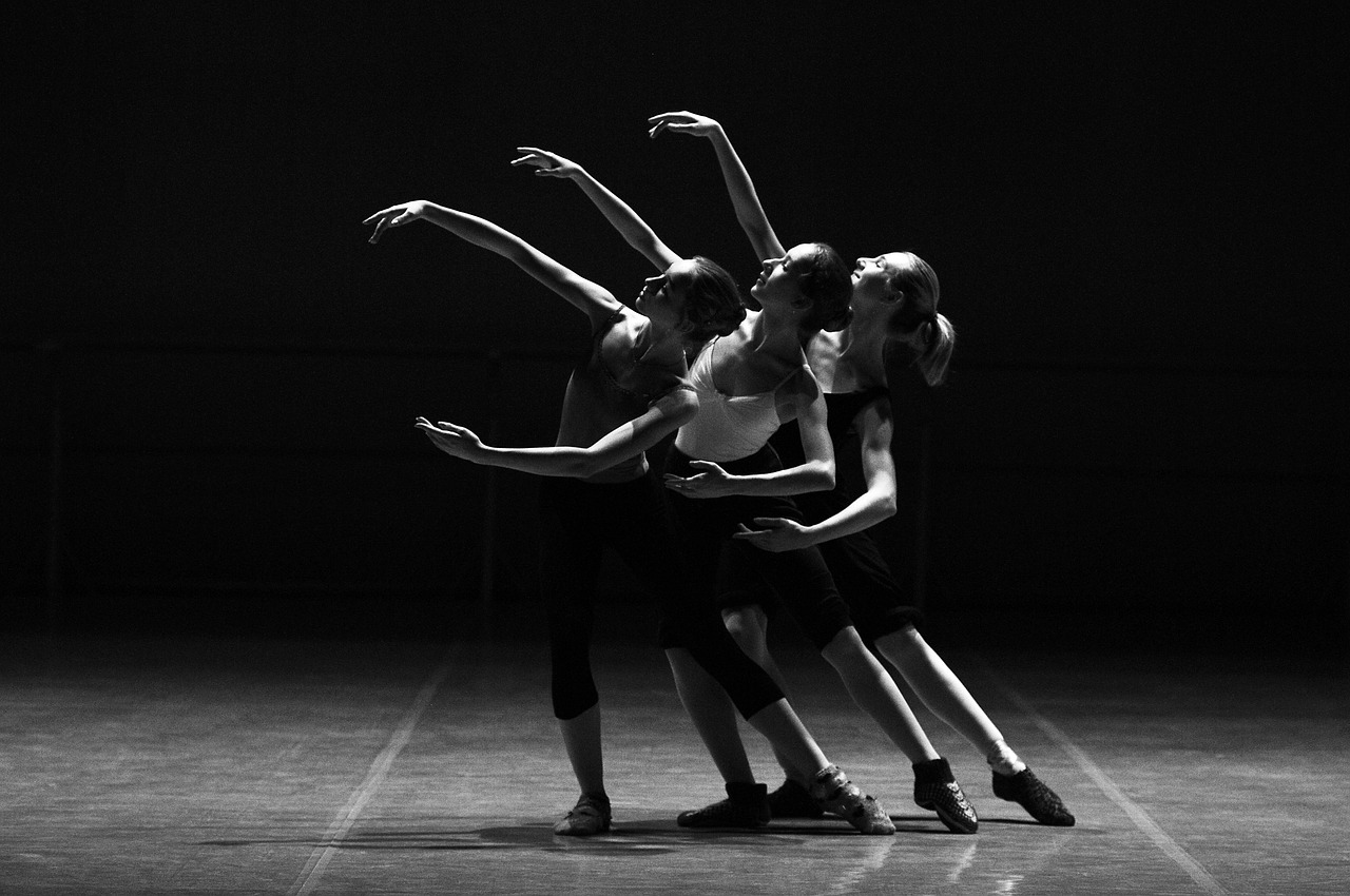 Ballet dancers performing on stage in black and white