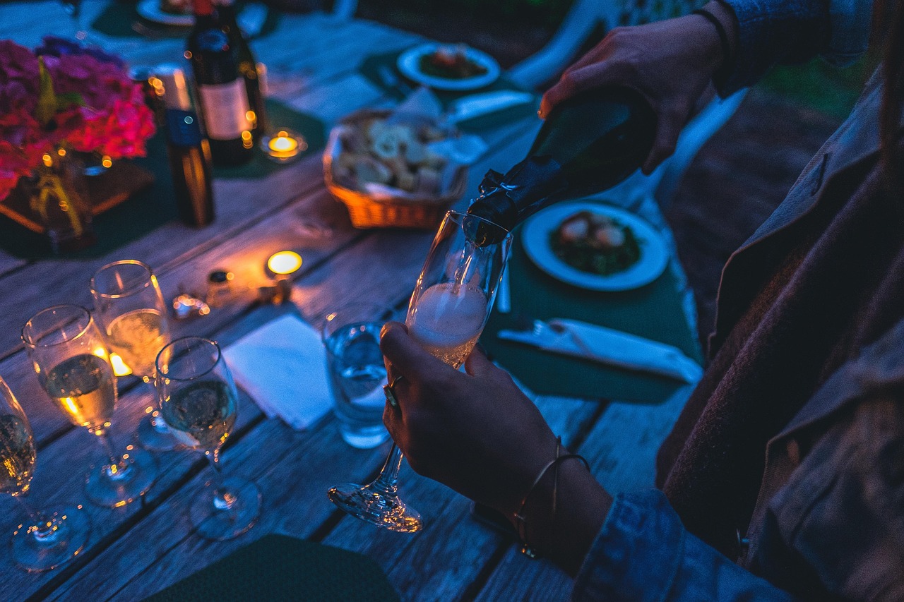 Champagne being poured into elegant glasses at an evening celebration