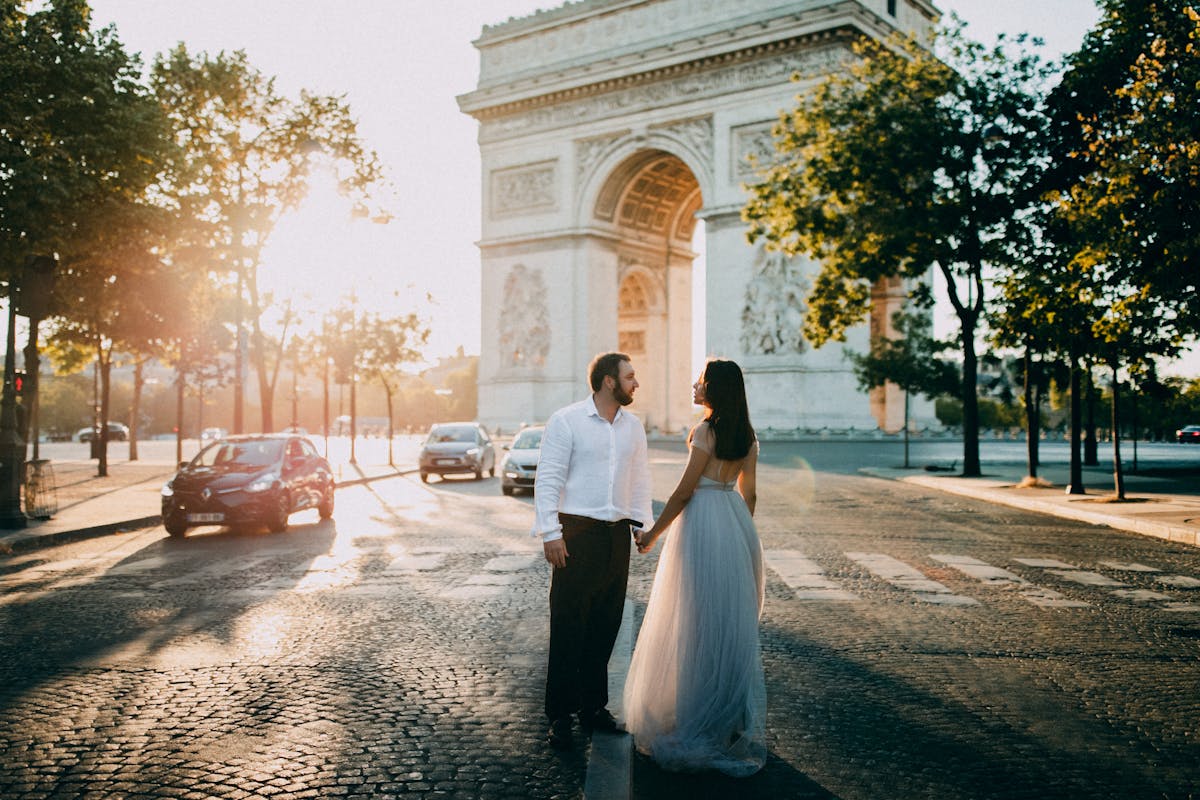 Romantic couple near the Arc de Triomphe at sunset in Paris