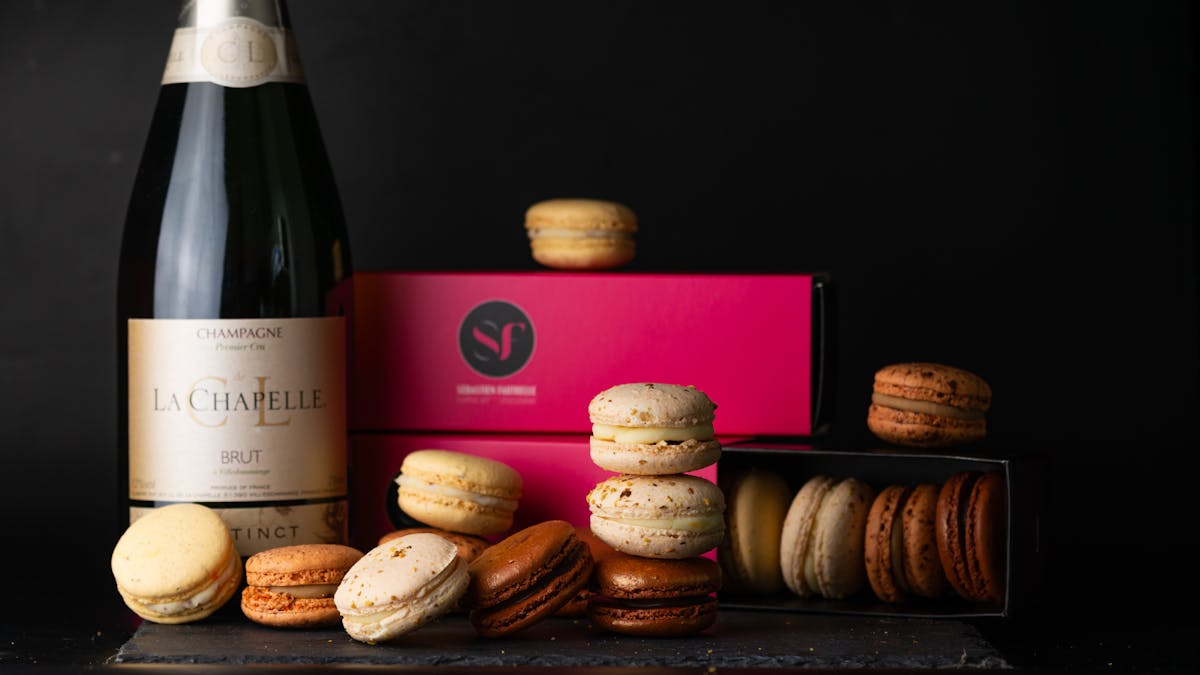Elegant display of French macarons alongside a bottle of champagne
