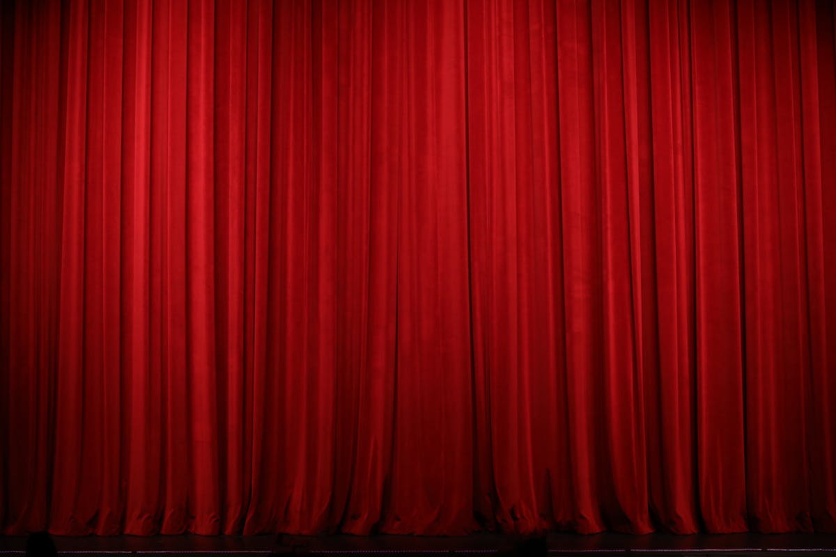 Elegant red theatre curtains creating a dramatic stage backdrop