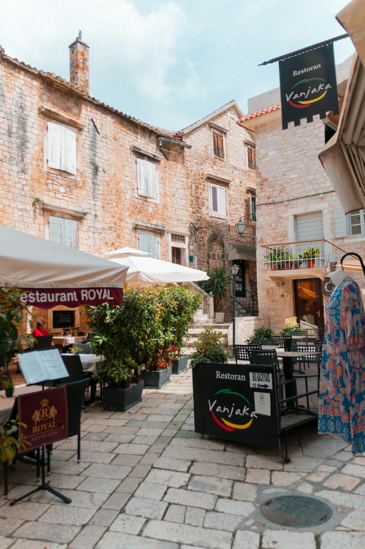 Outdoor dining in Trogir, Croatia with rustic stone architecture