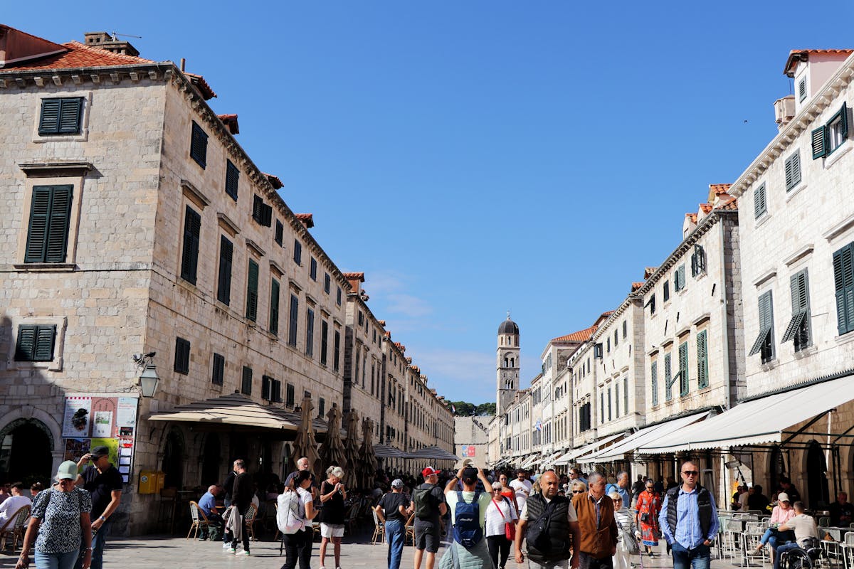 Vibrant atmosphere of Dubrovnik's historic streets under bright sun