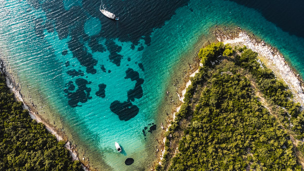 Boats near Lopud Island with hills and charming town