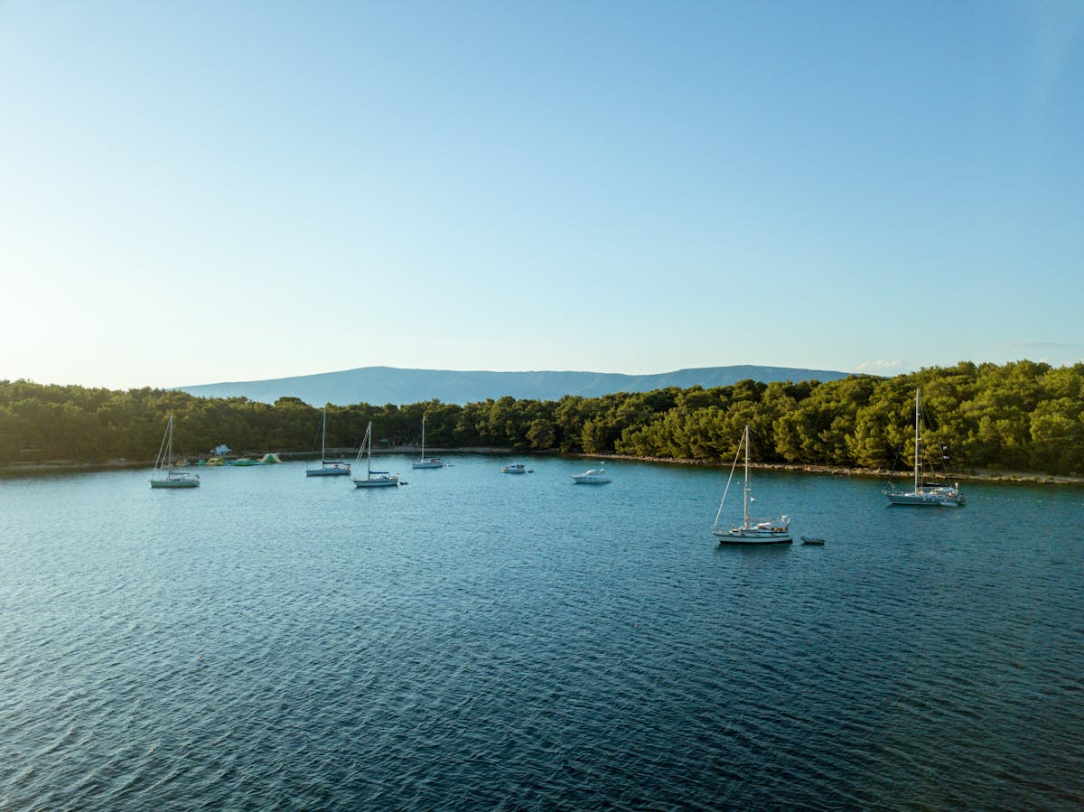 Sailboats anchored near Vrboska, Croatia under clear sky