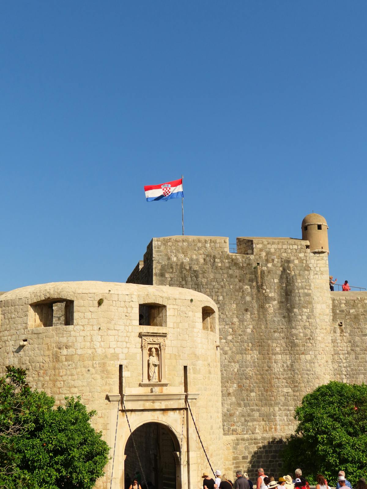 Dubrovnik stone fortifications under clear blue sky