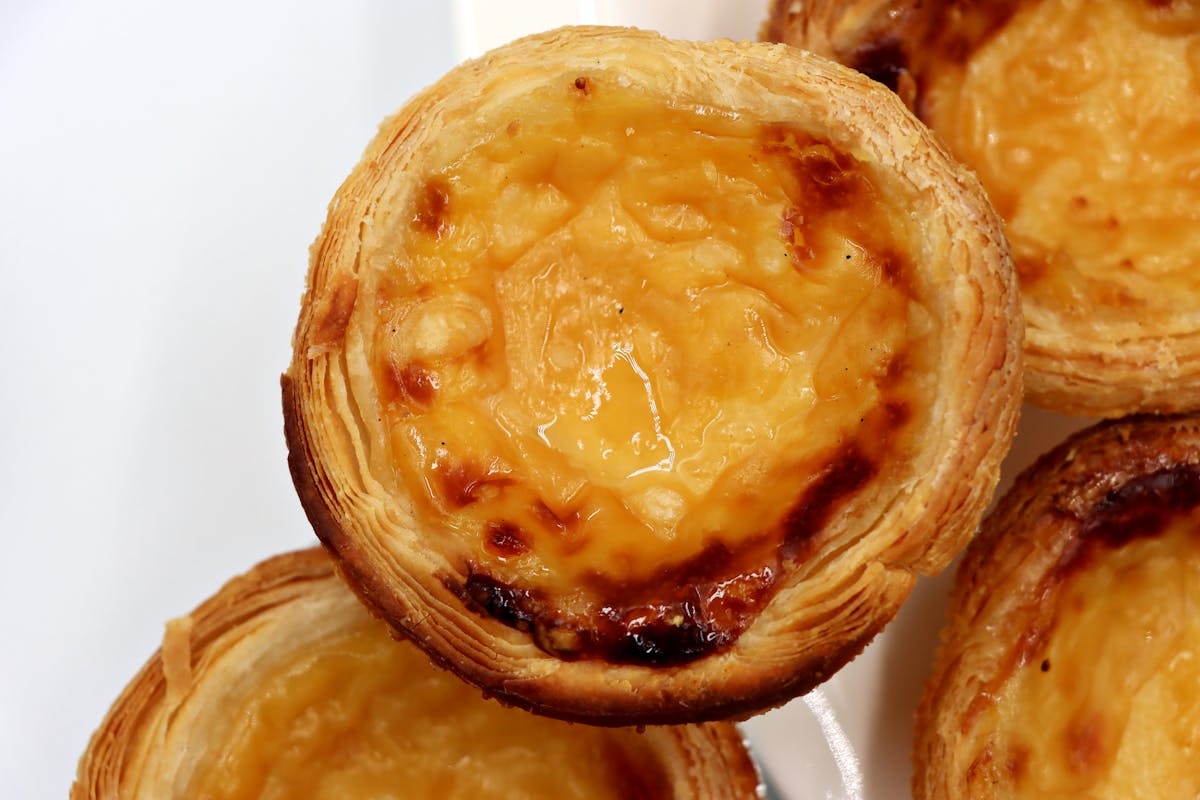 Close-up of traditional Portuguese custard tarts with creamy filling and flaky pastry