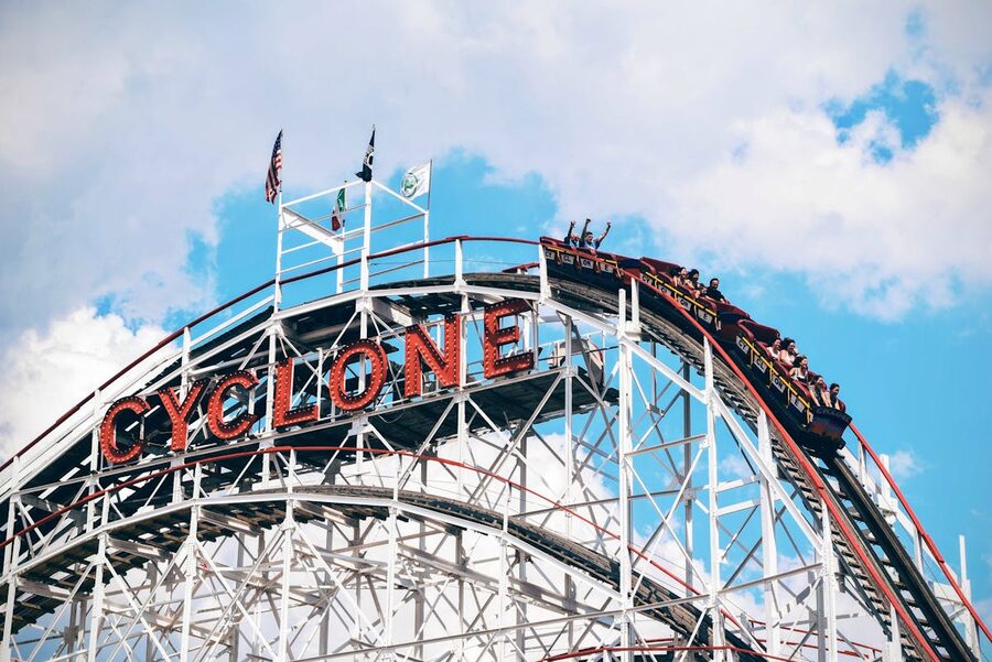 Classic roller coaster climbing the first hill at a theme park
