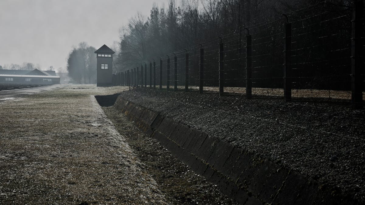 Barbed wire fence and watchtower at Dachau Concentration Camp Memorial