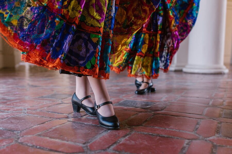 Close-up of dancers feet in traditional skirts and black shoes
