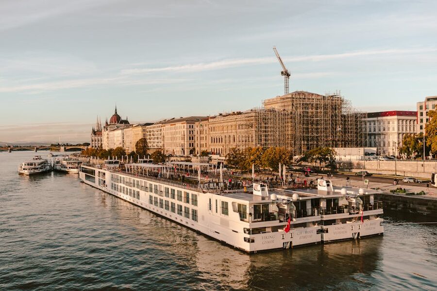 Danube river cruise boat in Budapest with city behind