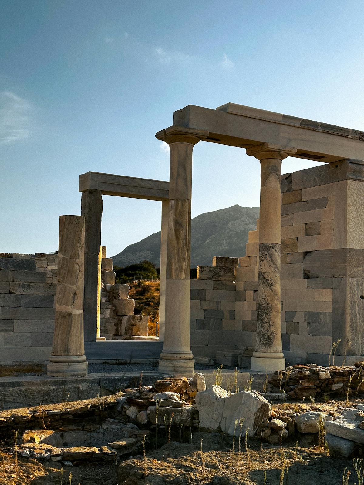 Ancient Greek temple ruins with tall stone columns against blue sky